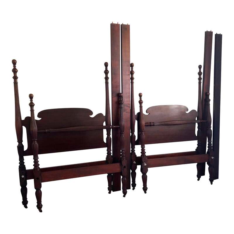 These early 20th-century set of mahogany Federal style carved twin beds are the perfect addition to any room! Excellent in a kids room, great for siblings or sleepovers, lovely in a guest room or fun in a bunk room at your weekend cottage! This pair of beds are very clean and includes two (2) headboards, two (2) footboards, and four (4)side rails. Beds are on casters and have beautifully carved blanket rails.