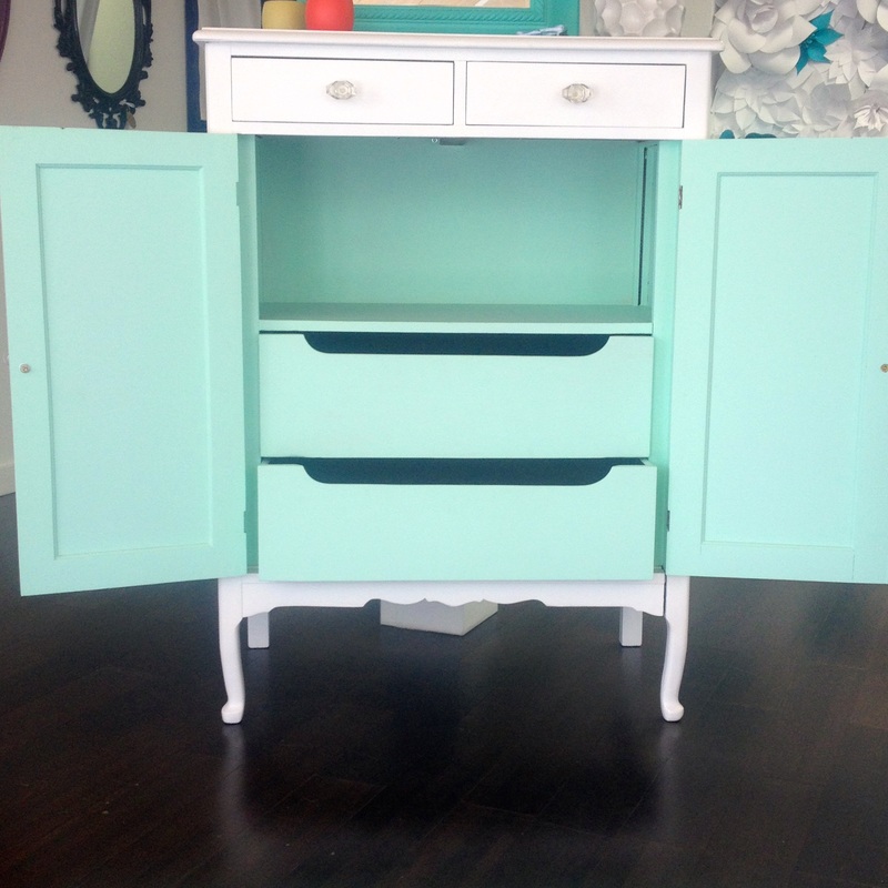 White cabinet with mint dresser