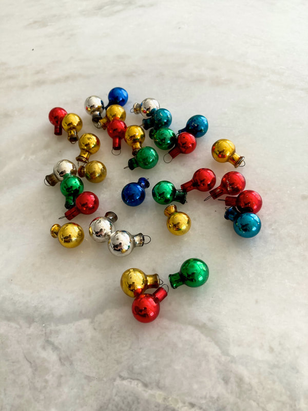 Bring some Christmas holiday charm to your home with these vintage multi-colored miniature glass ornaments. Set of 32. Includes: 5 Silver, 5 Green, 5 Blue, 8 Red, 9 Gold