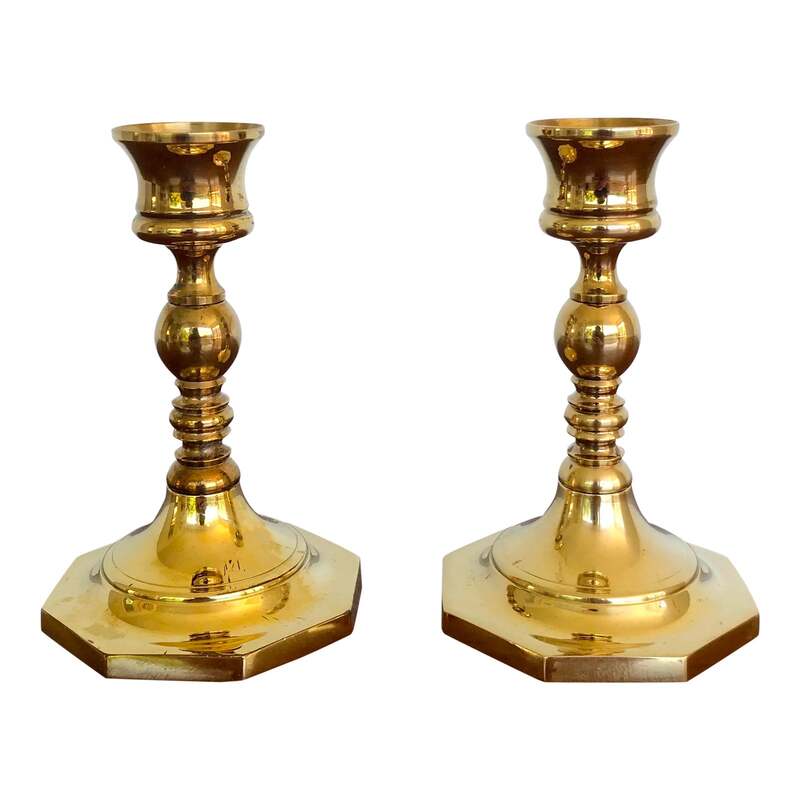 A  set of two heavy brass candle holders with octagonal bases. Great for mixing and matching. Marked with an 