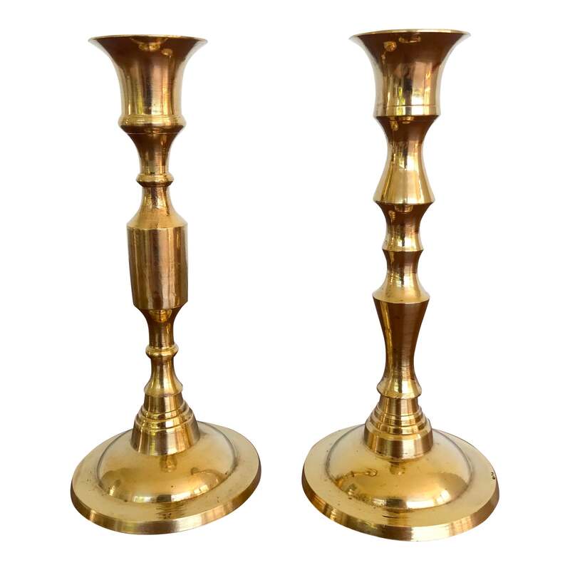 Two vintage brass candle holders. They are the same size but have different body designs. Marked 