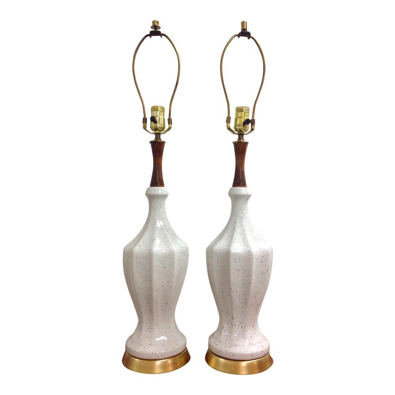 Great pair of Mid-Century Modern table lamps with an unique shape, gold speckled white body, wood neck and gold base. Each lamp has original wiring and is in working condition. The lamps have 2 different finials.  Base diameter measures 6